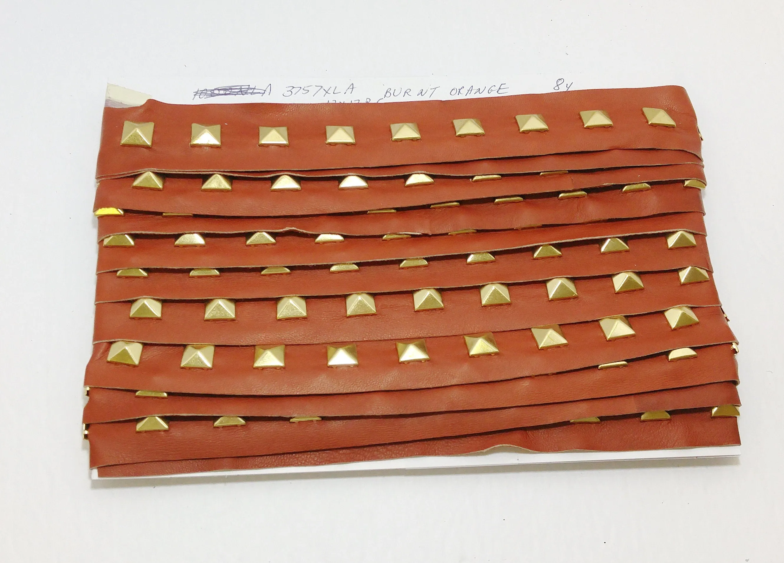 1 YD of 1-1/2" wide Genuine Lamb Leather Trim with Gold Square Pyramid Nailheads edge binding; top stitch; Burnt Orange 3757XLA